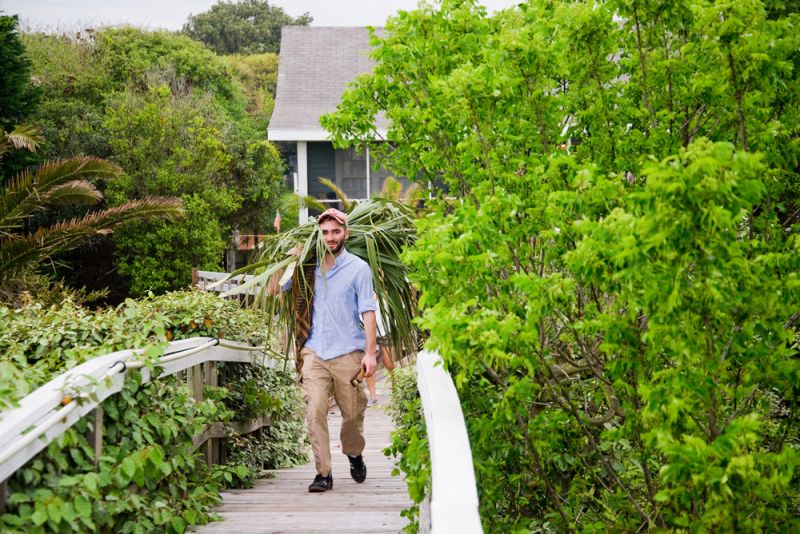 Art intern Emmanuel Echeverri hauls in some fronds for the next shot.