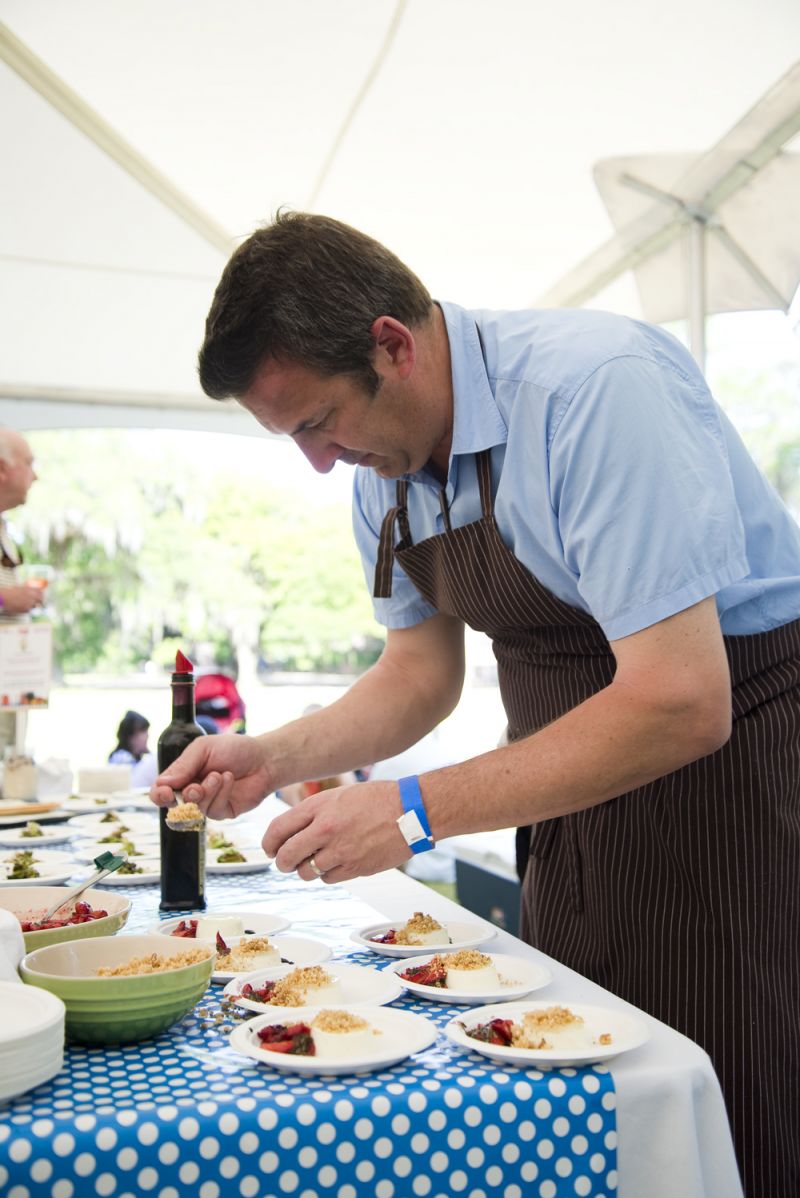 Owner and chef of The Grocery, Kevin Johnson prepares Burden Creek goat cheese panna cotta topped with strawberries, basil, and almond crumble.